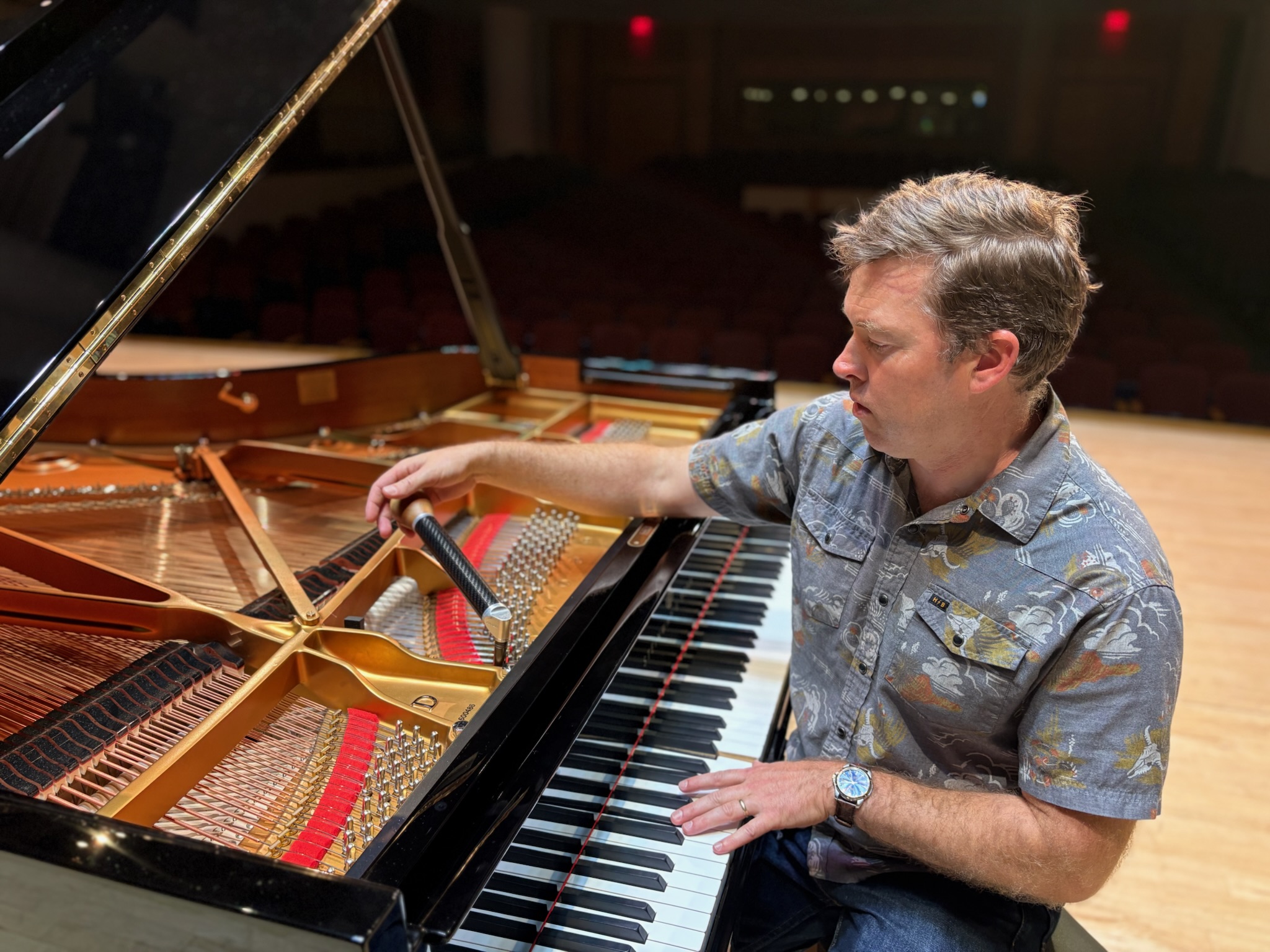Brian Turano Tuning a concert grand piano In Sursa Hall Ball State University